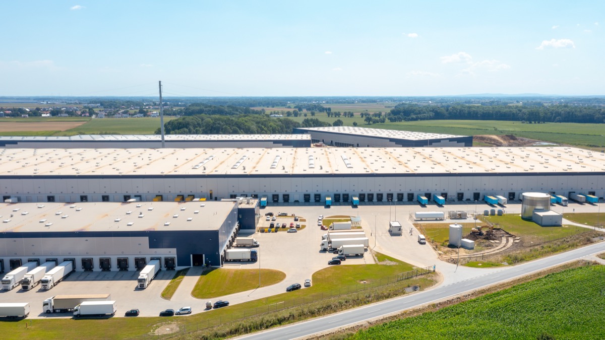 Aerial view of a commercial logistics estate with loading docks and trucks